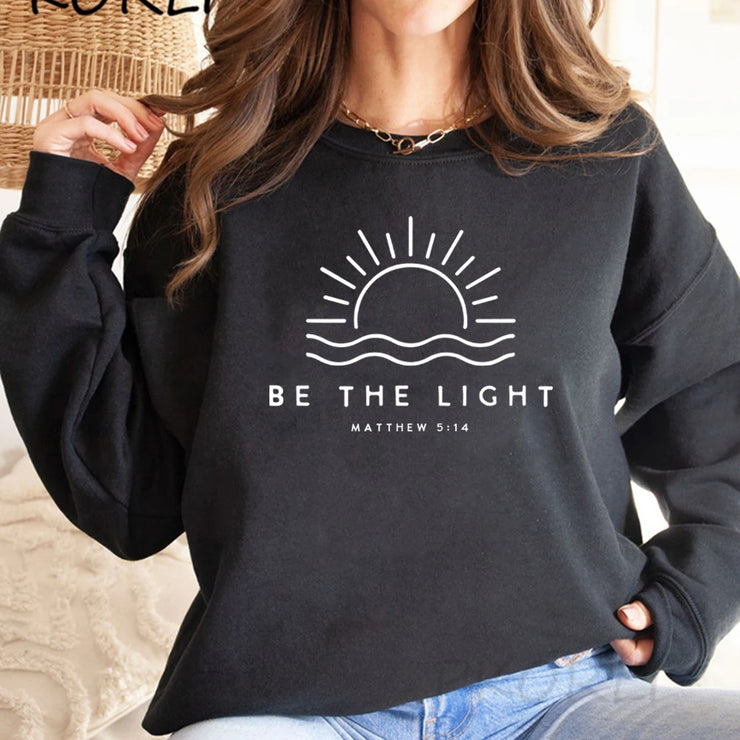 Black sweatshirt with Be The Light Bible verse clothing design Matthew 5:14 by Fresh Faith Designs