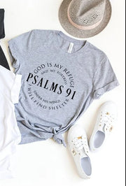 Gray Bible Verse Cotton Tee with Psalms 91 scripture printed in black paired with white sneakers and a straw hat