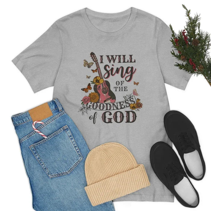 Gray Bible verse faith shirt for women with floral guitar design paired with jeans hat and black shoes