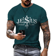 Casual faith graphic t-shirt in teal with Jesus saved my life design worn by tattooed man