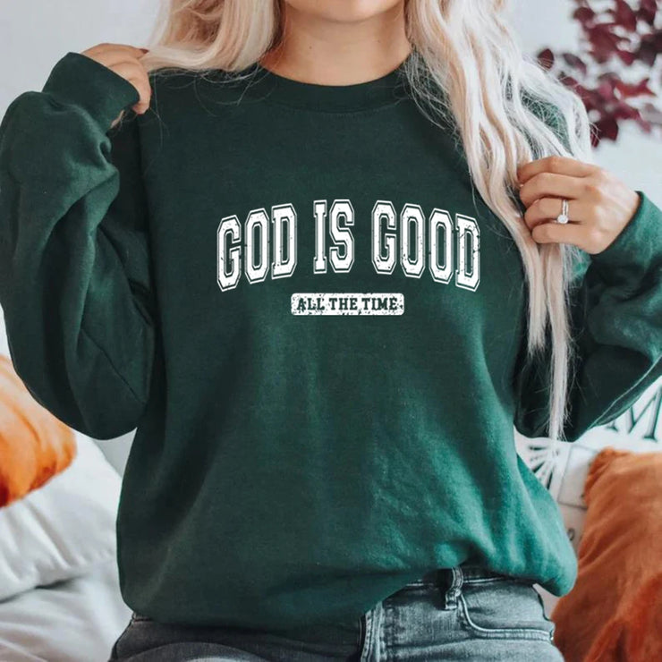 Woman wearing dark green sweatshirt with God Is Good print, Christian apparel for women by Fresh Faith Designs