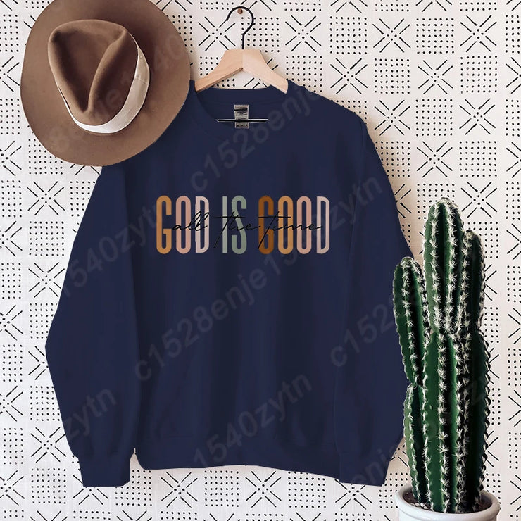 Navy blue Christian clothing women sweatshirt with God is Good text hanging next to brown hat and cactus