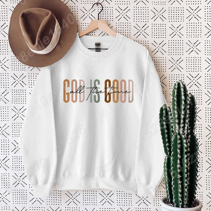 White sweatshirt with God is Good call the fence design, styled with brown hat and cactus, Christian clothing women