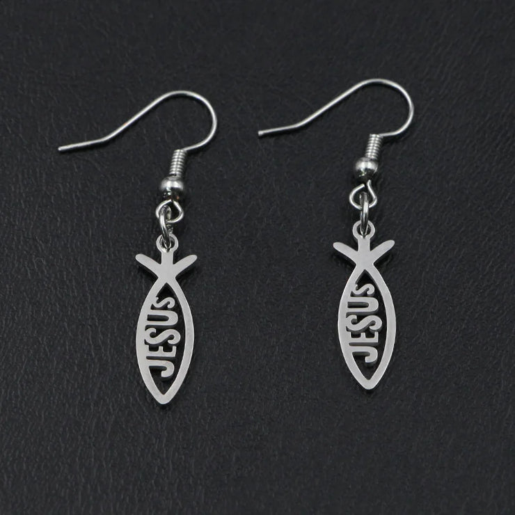 Silver Christian fish earrings with JESUS cutout design by Fresh Faith Designs on black background