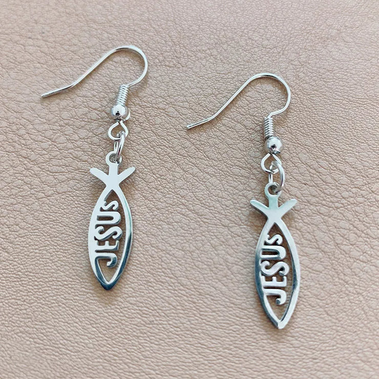 Fresh Faith Designs silver Christian fish earrings with Jesus cutout on beige background