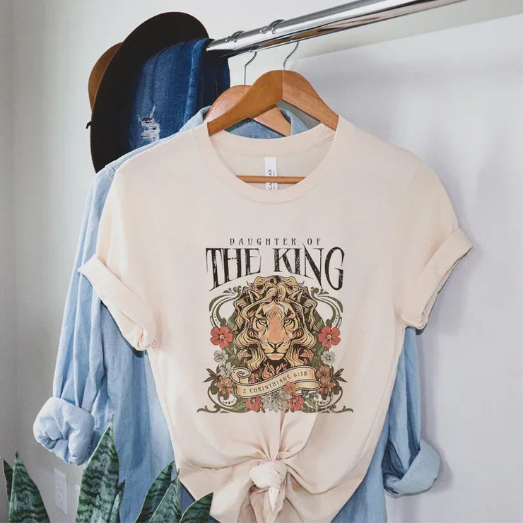 Christian graphic tee for women by Fresh Faith Designs with Daughter of the King lion print