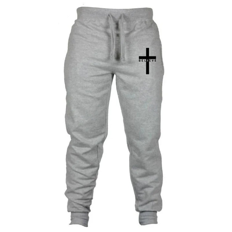 Gray Christian jogging pants with drawstring waist and black cross design with believe text