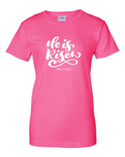 Pink He is Risen Christian seasonal clothing t-shirt with white script design and God is Good text