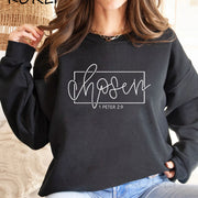 Fresh Faith Designs black Christian women's sweatshirt with chosen 1 Peter 2:9 scripture print