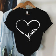 Black Christian women's t-shirt with white heart and Jesus script design hanging on wooden hanger