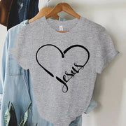 Gray Christian women's t-shirt with black heart and Jesus script design hanging on wooden hanger