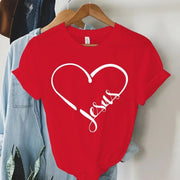 Red Christian women's t-shirt with white heart and Jesus script design hanging on wooden hanger