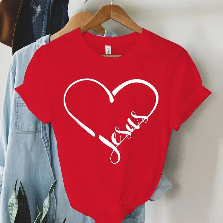 Red Christian women's t-shirt with white heart and Jesus script design hanging on wooden hanger
