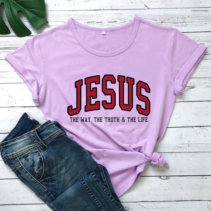 Lavender Christian women's vintage t-shirt with Jesus graphic and text paired with blue denim jeans