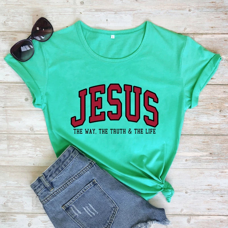 Christian women's vintage t-shirt in green with Jesus graphic and paired with denim shorts and sunglasses