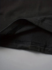 Close-up of black fabric hem detailing on faith-based casual clothing by Fresh Faith Designs
