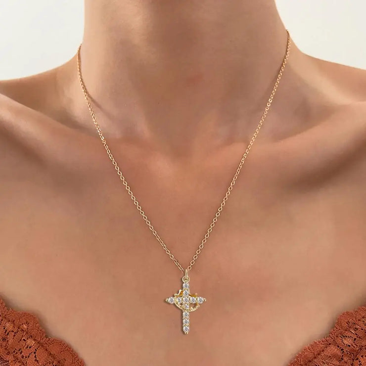 Faith-based cross necklace with gold chain and sparkling stones worn on neck