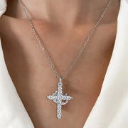 Elegant silver faith-based cross necklace with sparkling stones worn on a delicate chain