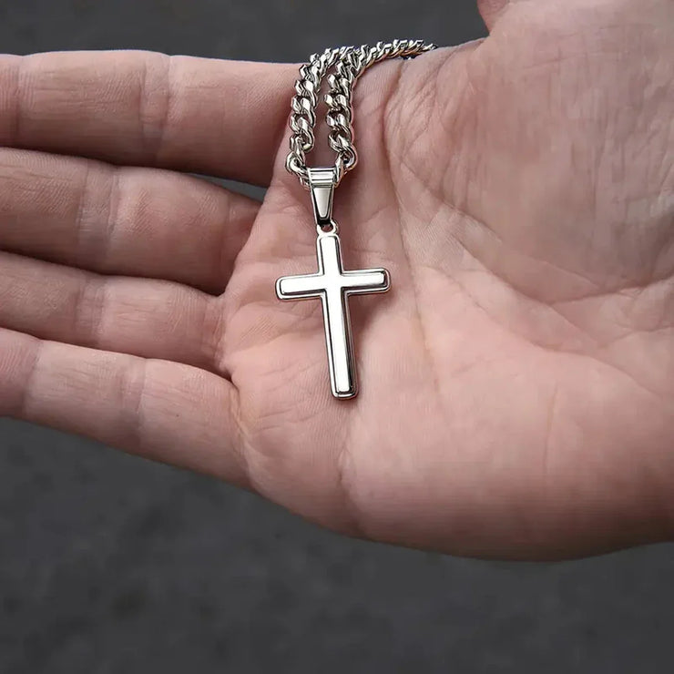 Silver cross pendant necklace held in hand faith based jewelry gift for son by Fresh Faith Designs