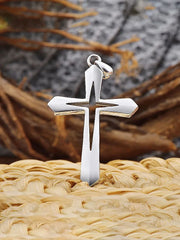 Silver cross pendant representing faith based men's jewelry by Fresh Faith Designs on woven background