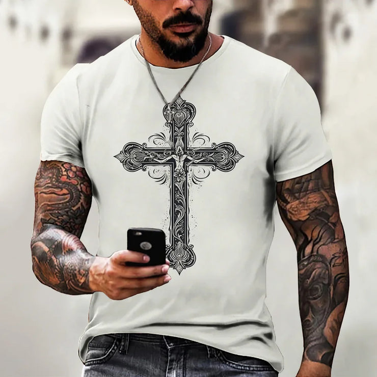 White faith based men's t-shirt with intricate black cross design worn by tattooed man holding a phone
