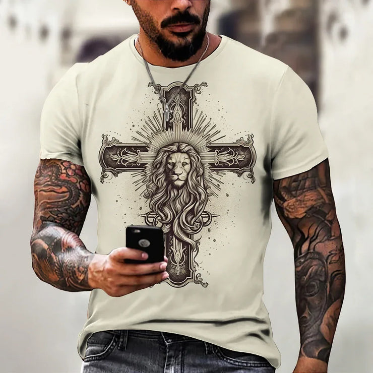 Faith based men's t-shirt with lion and cross design worn by tattooed man holding phone