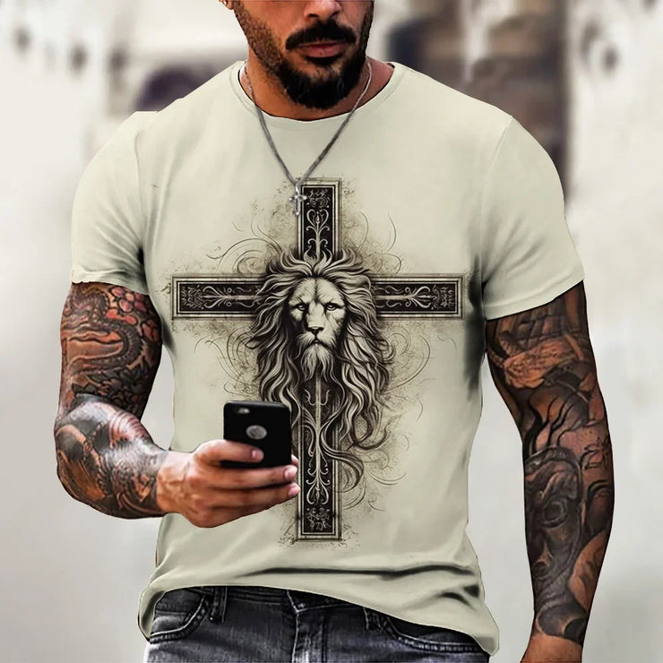 Faith based men's t-shirt featuring a lion and cross design worn by tattooed man holding smartphone
