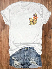 White t-shirt with floral design paired with distressed denim shorts in faith based summer apparel style