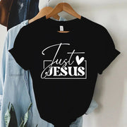 Black faith-based women's apparel t-shirt with Just Jesus white text design on hanger