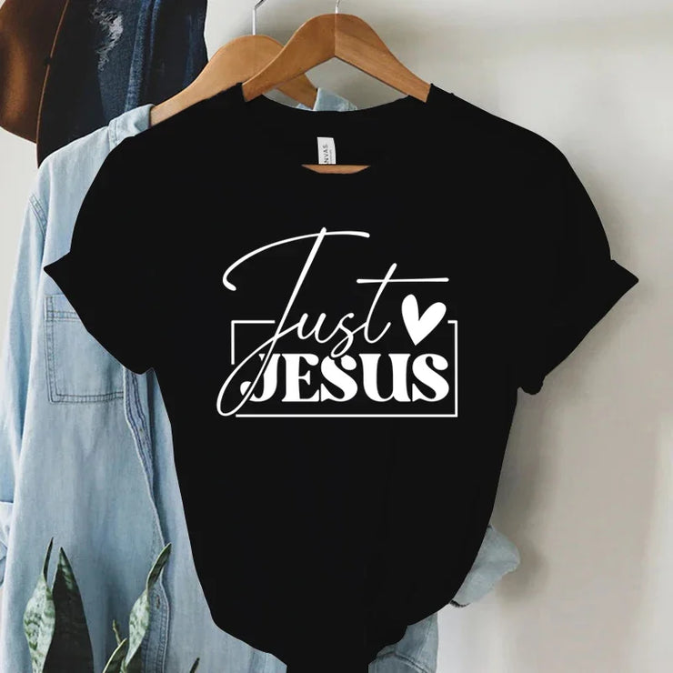 Black faith-based women's apparel t-shirt with Just Jesus white text design on hanger