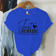 Blue Just Jesus t-shirt from faith-based women's apparel by Fresh Faith Designs hanging on wooden hanger