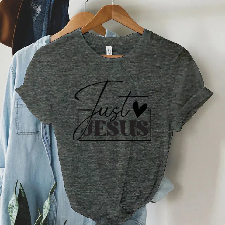 Gray Just Jesus graphic t-shirt hanging on wooden hanger from Fresh Faith Designs faith-based women's apparel