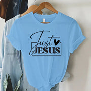 Light blue faith-based women's apparel t-shirt with Just Jesus black text and heart design