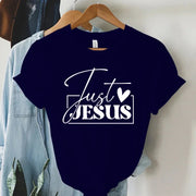 Navy blue faith-based women's apparel t-shirt with Just Jesus white graphic print on hanger