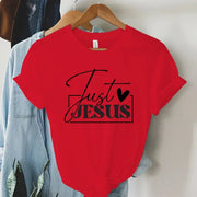 Red short sleeve t-shirt with Just Jesus print hanging on wooden hanger faith-based women's apparel