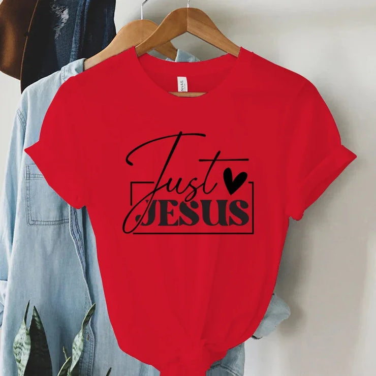 Red short sleeve t-shirt with Just Jesus print hanging on wooden hanger faith-based women's apparel