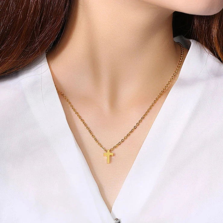Gold cross necklace on woman wearing white blouse faith jewelry for women by Fresh Faith Designs