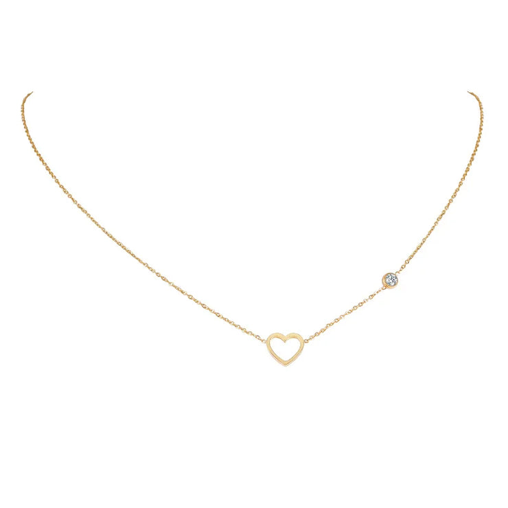 Delicate gold heart necklace with small crystal accent, a stylish piece of faith jewelry for women