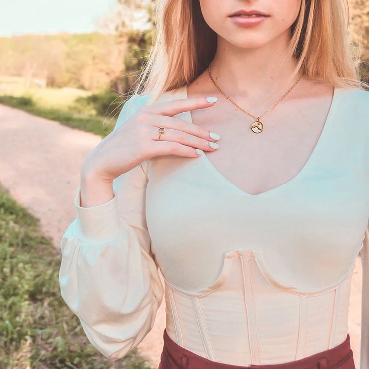 Fresh Faith Designs gold necklace worn by woman featuring faith jewelry for women with a delicate pendant