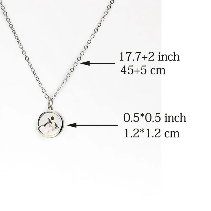 Fresh Faith Designs silver necklace with circular pendant featuring mountain and sun design faith jewelry for women