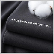 Fresh Faith Designs Love Like Jesus graphic tee made of soft black cotton fabric folded with cotton flower