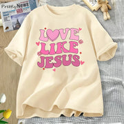 Fresh Faith Designs Love Like Jesus graphic tee in cream with pink lettering and heart design