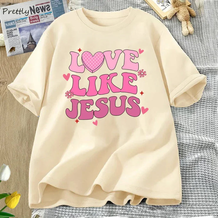 Fresh Faith Designs Love Like Jesus graphic tee in cream with pink lettering and heart design