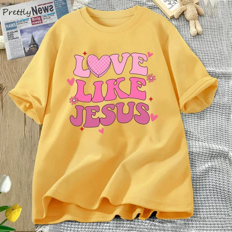 Yellow Love Like Jesus graphic tee by Fresh Faith Designs with pink heart and flower design