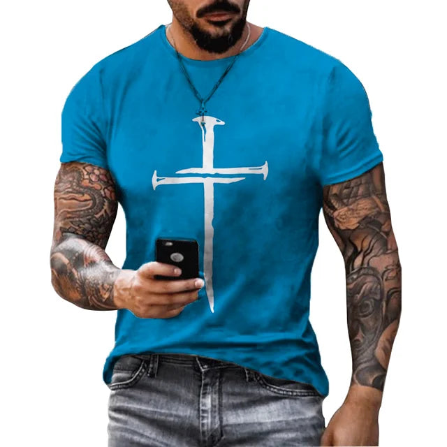 Men's Christian Cross T-shirt in blue with silver cross design worn by tattooed man holding phone