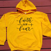Yellow hoodie with faith over fear design, religious casual apparel for everyday wear