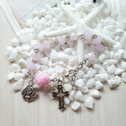 Fresh Faith Designs religious jewelry for women featuring a pink beaded bracelet with cross and rose charms