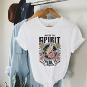 White t-shirt with Christian inspirational graphic tees design featuring dove, flowers, and the text where the spirit is there is freedom