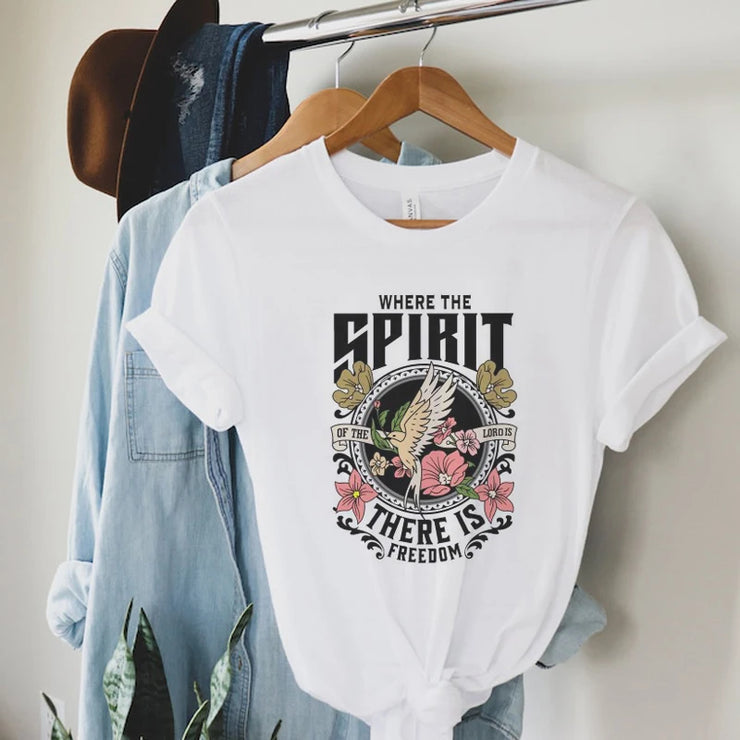White t-shirt with Christian inspirational graphic tees design featuring dove, flowers, and the text where the spirit is there is freedom