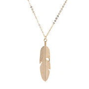 Gold feather pendant necklace on delicate chain from Fresh Faith Designs fashion crystal cross necklace collection